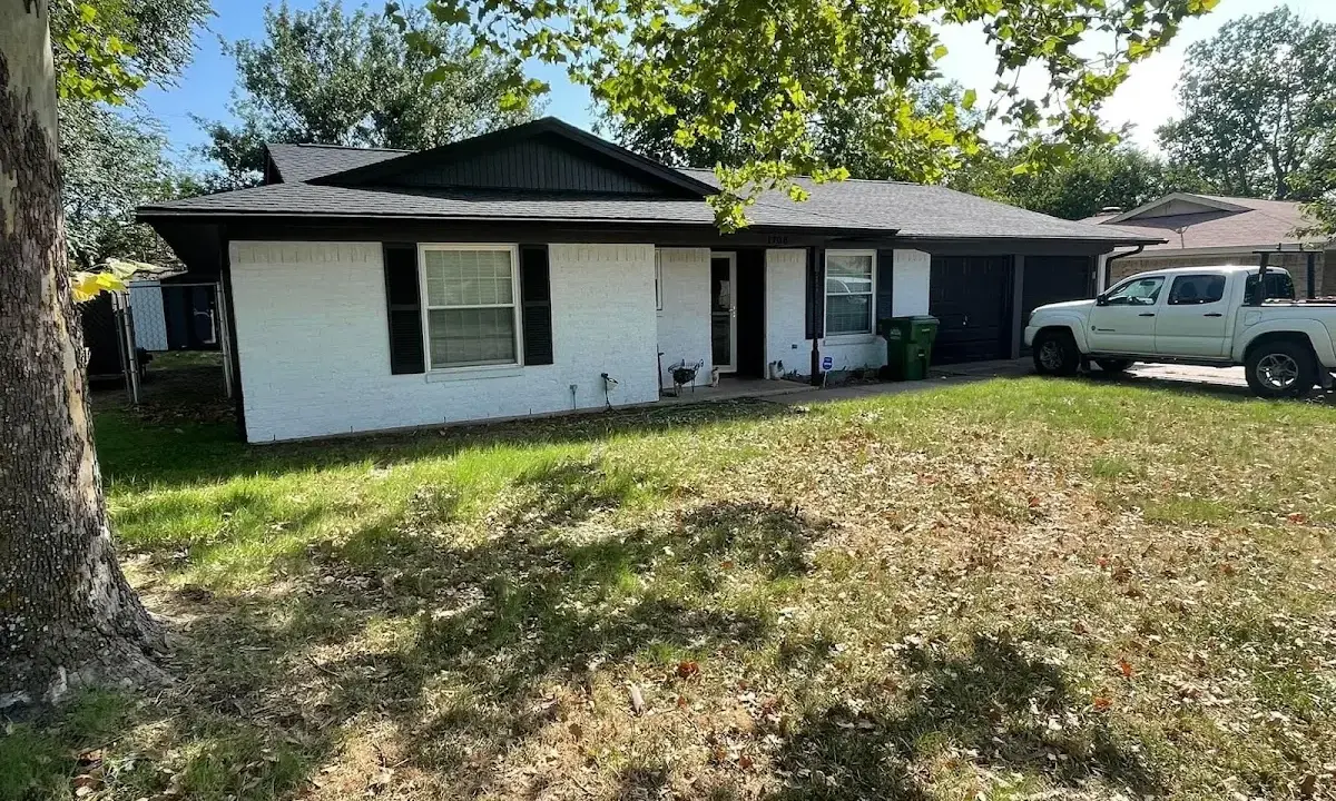 Professional roofing crew working on a residential roof in Commerce